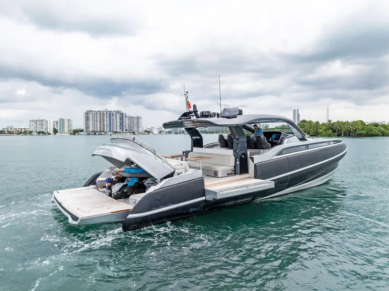 Slide: The Image of 2022 SACS Rebel 55 luxury yacht cruising on a calm waterway. - 0