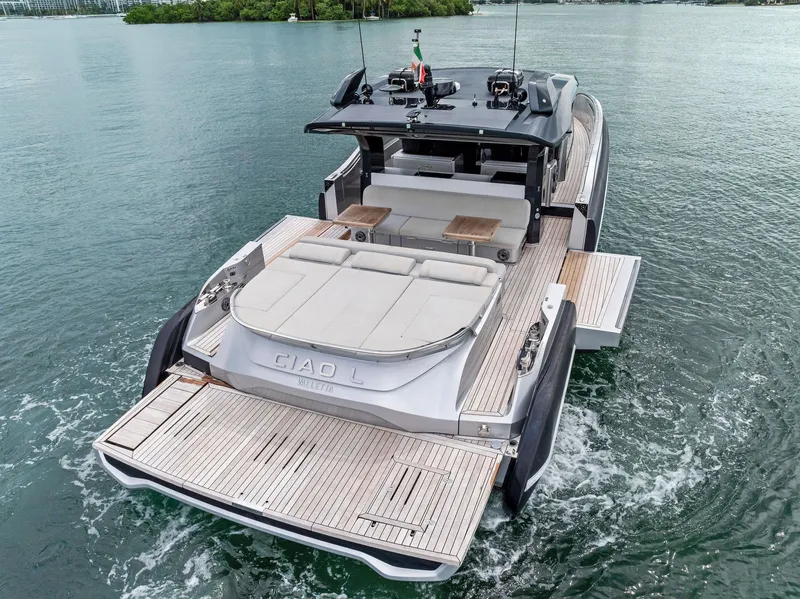 Slide: The Image of 2022 SACS Rebel 55 luxury yacht on calm water, rear view. - 20