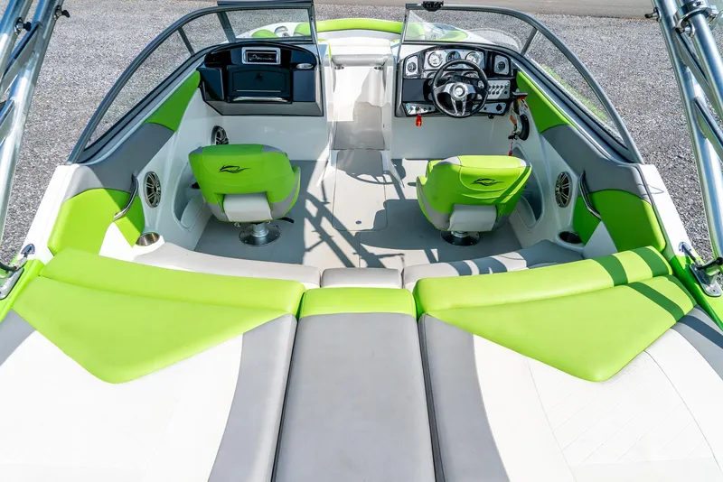 Slide: The Image of 2014 Rinker Captiva 200 MTX boat interior with green and white seating. - 10
