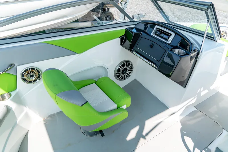 Slide: The Image of 2014 Rinker Captiva 200 MTX boat interior with green and gray seating, modern dashboard. - 12