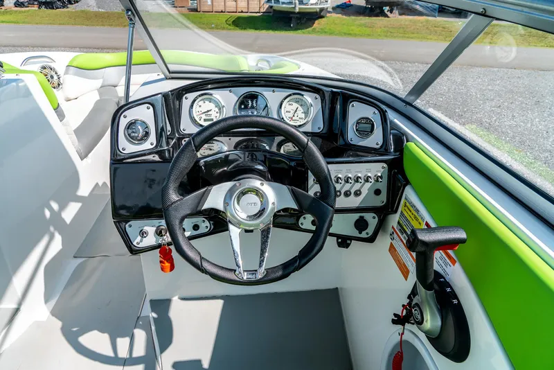 Slide: The Image of 2014 Rinker Captiva 200 MTX boat dashboard with steering wheel and instrument panel. - 15