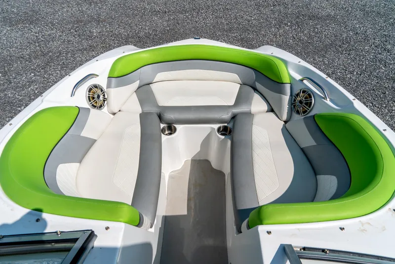 Slide: The Image of 2014 Rinker Captiva 200 MTX boat interior with green and gray seating. - 16