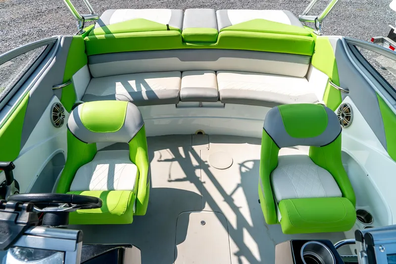 Slide: The Image of 2014 Rinker Captiva 200 MTX boat interior with green and white seating. - 18