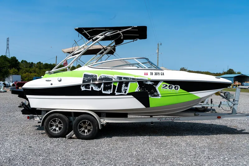 Slide: The Image of 2014 Rinker Captiva 200 MTX boat on trailer, vibrant green and black design. - 4