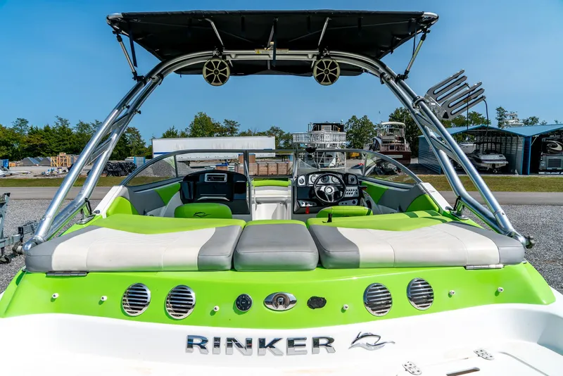 Slide: The Image of 2014 Rinker Captiva 200 MTX boat with green and white interior, docked outdoors. - 8