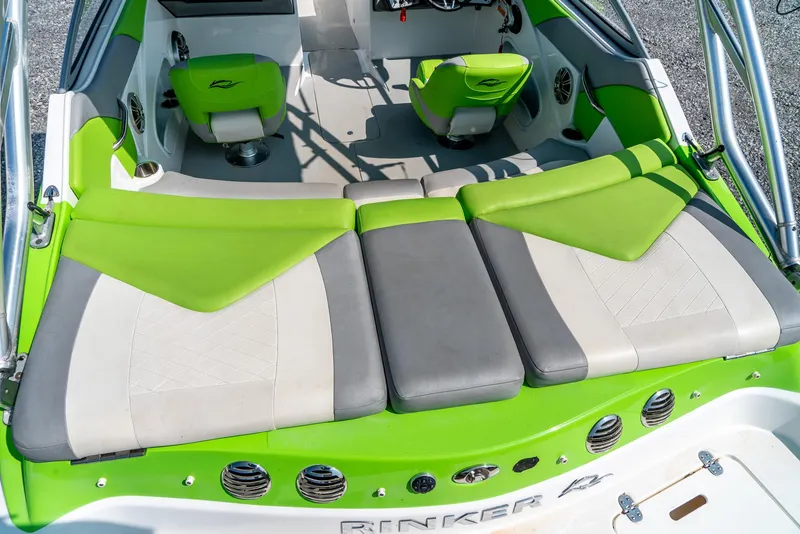 Slide: The Image of 2014 Rinker Captiva 200 MTX boat interior with green and gray seating. - 9