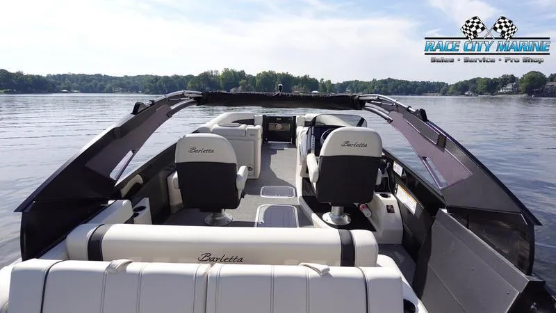 Slide: The Image of 2025 Barletta L25UCAT pontoon boat interior on a serene lake. - 10
