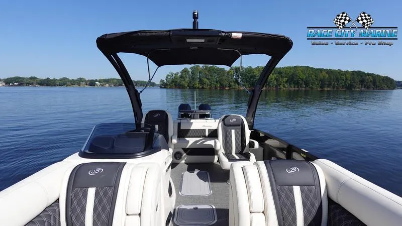 Slide: The Image of 2025 Barletta L25UCAT pontoon boat on a serene lake with lush greenery. - 11