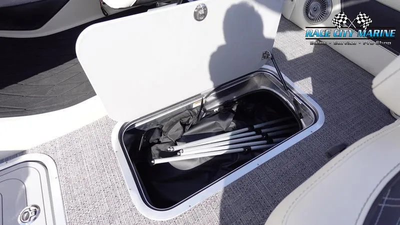 Slide: The Image of 2025 Barletta L25UCAT boat storage compartment with folded equipment inside. - 24
