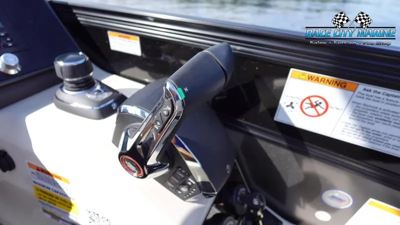 Slide: The Image of Close-up of 2025 Barletta L25UCAT boat controls with warning labels. - 27