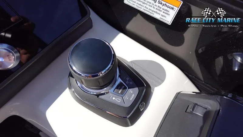 Slide: The Image of Control panel of 2025 Barletta L25UCAT boat with joystick and Race City Marine logo. - 28