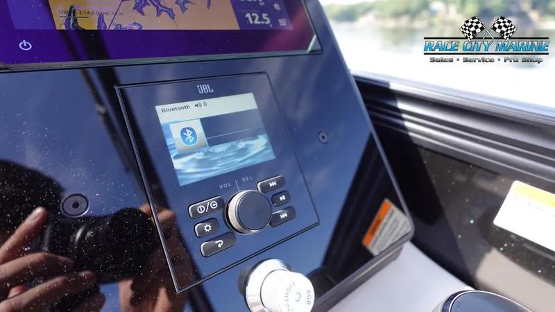 Slide: The Image of Barletta L25UCAT 2025 boat dashboard with JBL Bluetooth display and Race City Marine logo. - 29