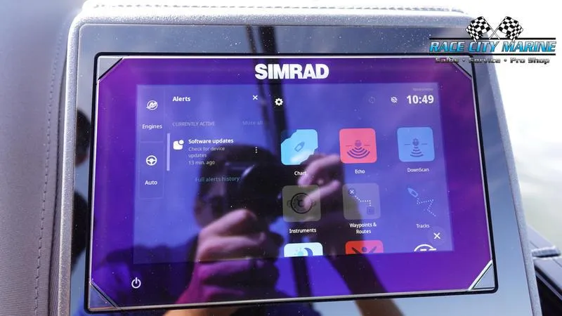 Slide: The Image of Simrad display on 2025 Barletta L25UCAT boat, showing software updates and alerts. - 31