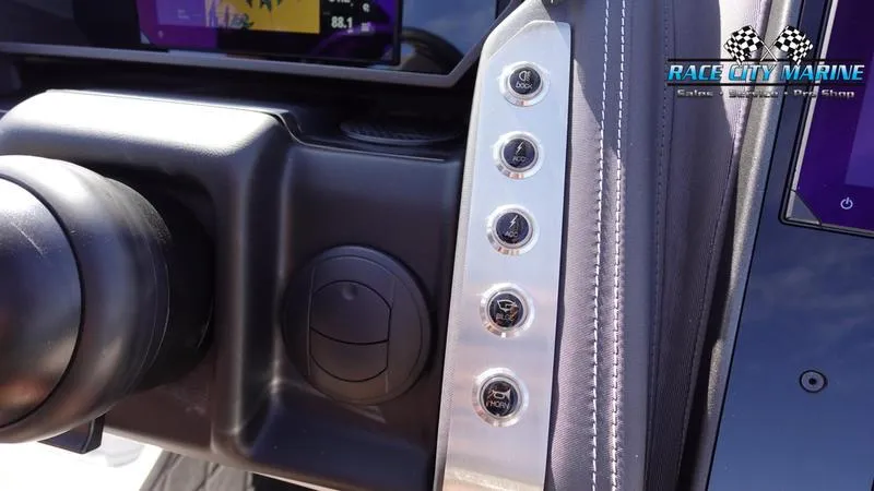 Slide: The Image of Close-up of 2025 Barletta L25UCAT dashboard controls with Race City Marine branding. - 32