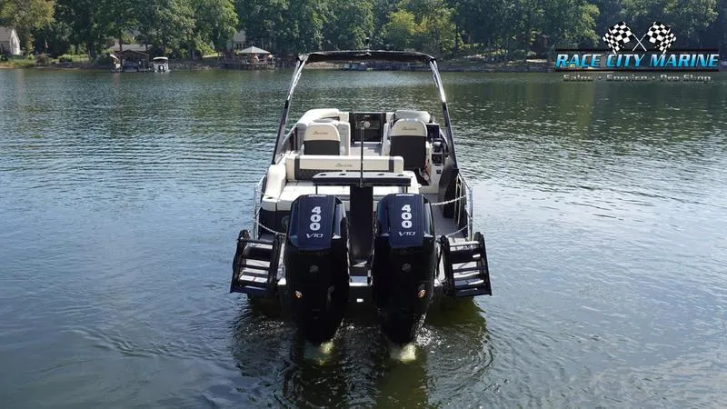 Slide: The Image of 2025 Barletta L25UCAT pontoon boat with dual 400 horsepower engines on a serene lake. - 4