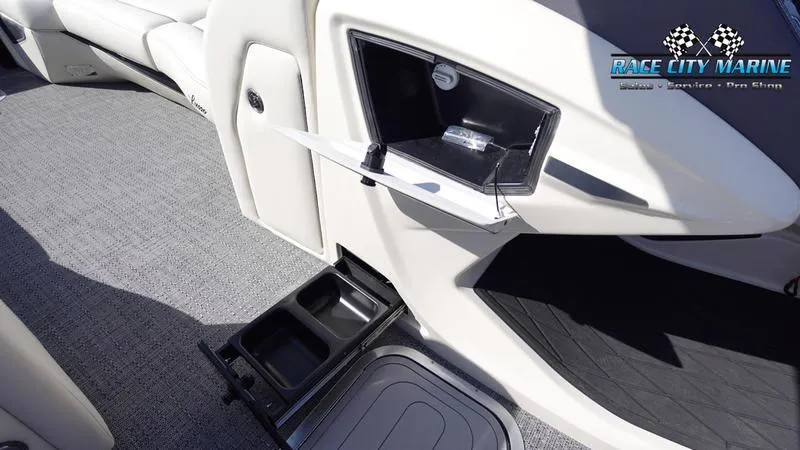 Slide: The Image of 2025 Barletta L25UCAT boat interior with cup holders and storage compartments. - 41