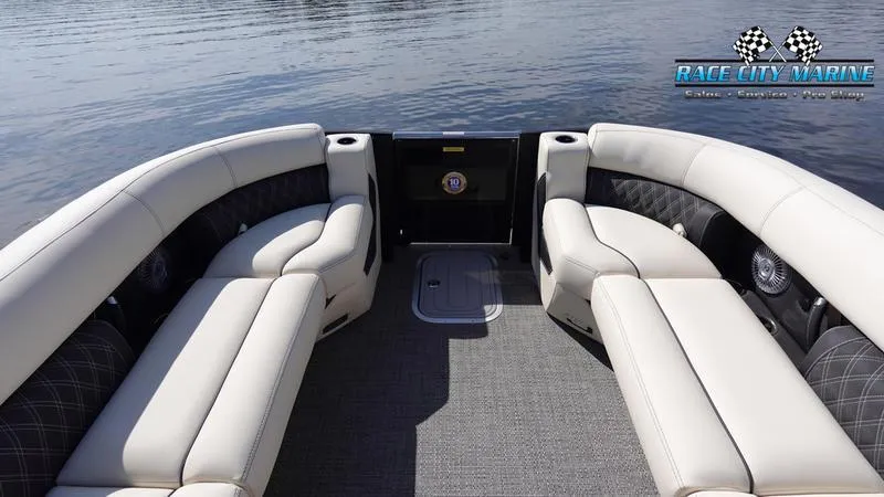 Slide: The Image of 2025 Barletta L25UCAT pontoon boat interior with plush seating on calm water. - 47