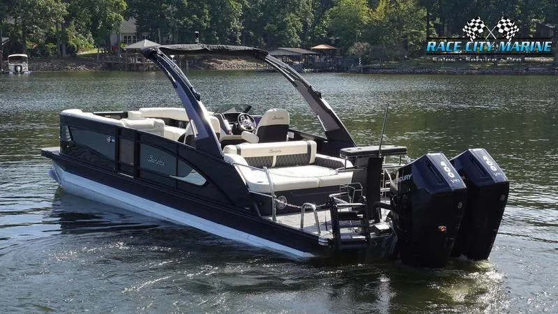 Slide: The Image of 2025 Barletta L25UCAT pontoon boat on a lake, featuring dual outboard motors. - 7