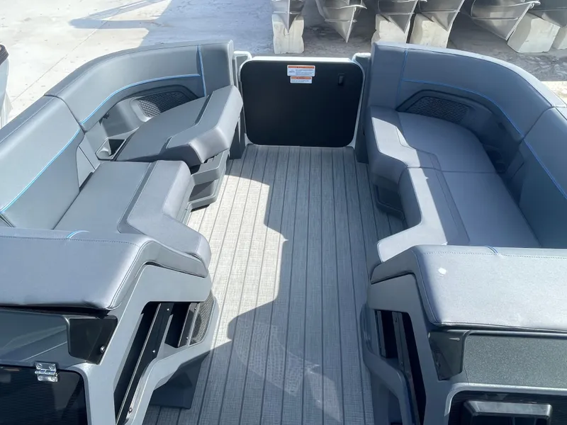 Slide: The Image of 2024 Manitou 22 Explore Switchback HSP575 boat interior with spacious seating. - 10