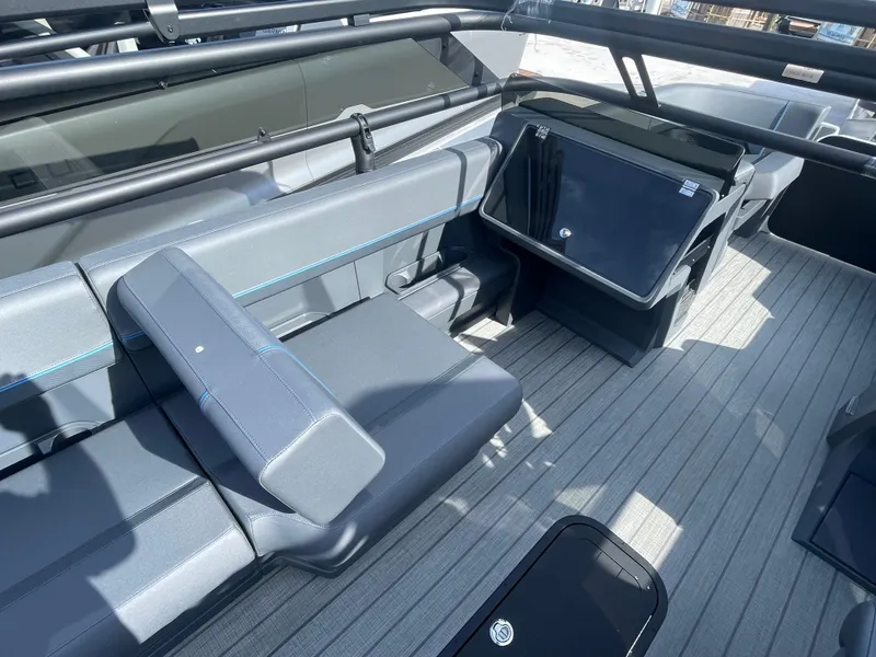 Slide: The Image of 2024 Manitou 22 Explore Switchback HSP575 boat interior with sleek seating and modern design. - 7