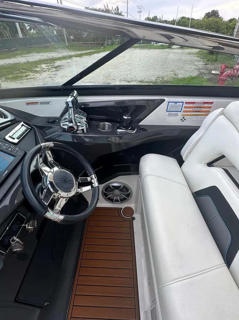 Slide: The Image of Interior of a 2014 Monterey 328 Super Sport boat with sleek design and modern controls. - 10