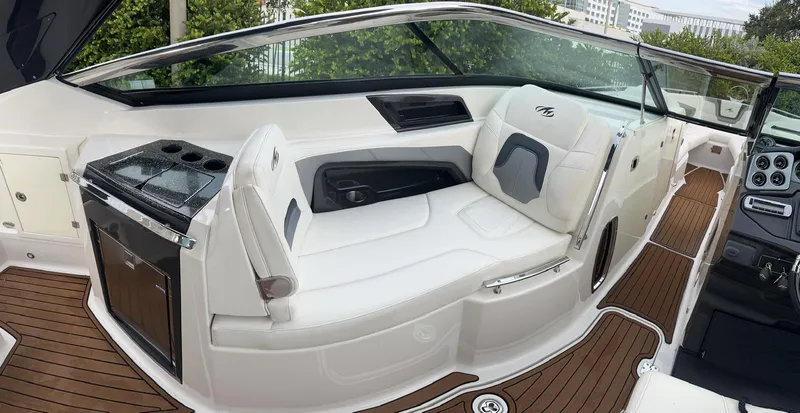 Slide: The Image of 2014 Monterey 328 Super Sport boat interior with white seating and wood accents. - 13