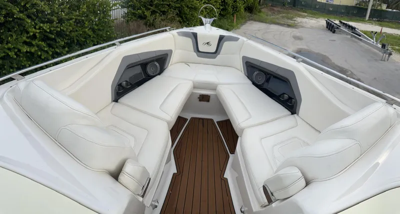 Slide: The Image of Luxurious 2014 Monterey 328 Super Sport boat interior with white seating and wood flooring. - 16
