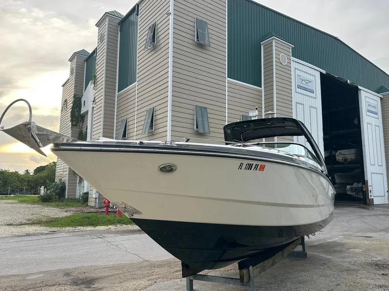Slide: The Image of 2014 Monterey 328 Super Sport boat docked near storage facility. - 2