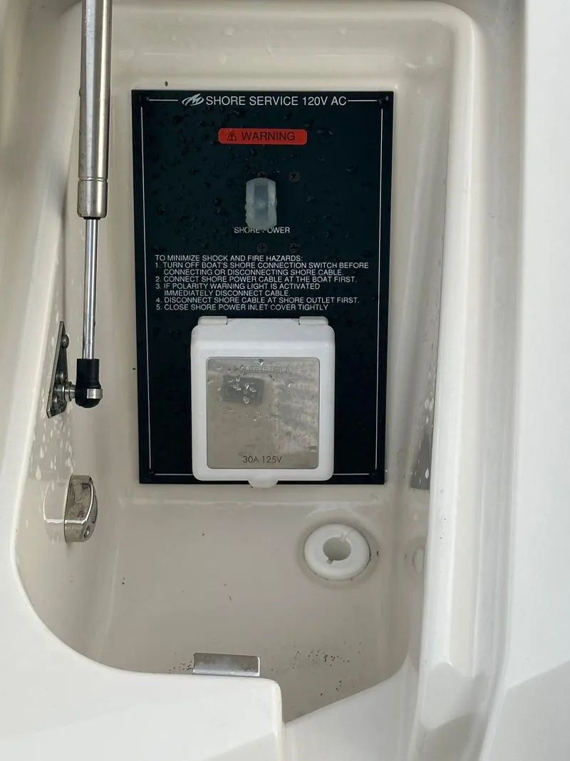 Slide: The Image of 2014 Monterey 328 Super Sport shore service panel with warning label and power socket. - 20