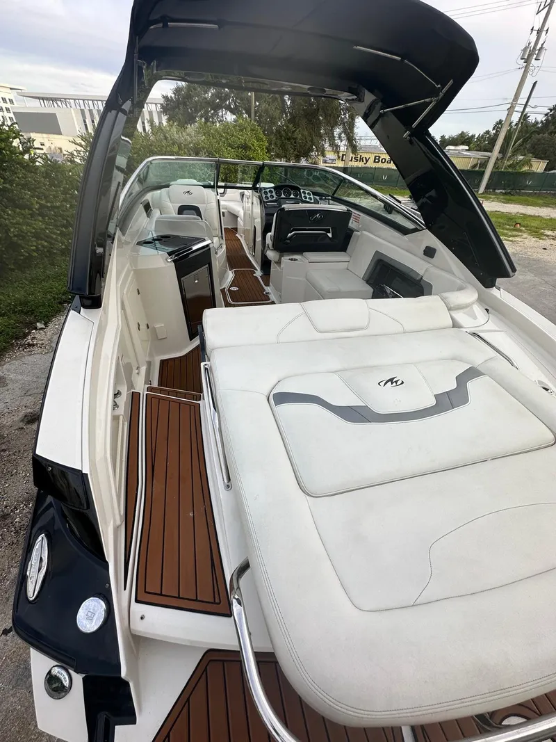 Slide: The Image of 2014 Monterey 328 Super Sport boat with sleek interior and wooden deck. - 5