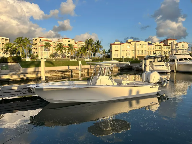 The Image of 2025 Valhalla Boatworks V-29 Hybrid docked in a marina with waterfront buildings. - 0