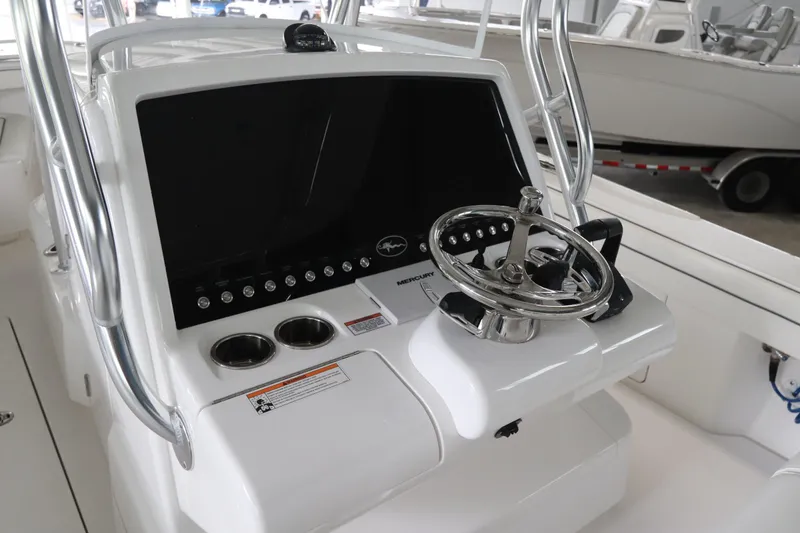 Slide: The Image of 2025 Valhalla Boatworks V-29 Hybrid helm with steering wheel and control panel. - 19