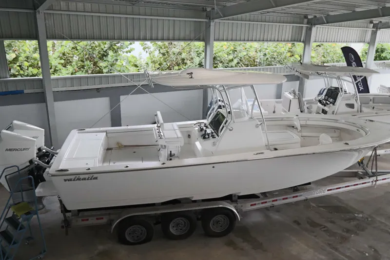 Slide: The Image of 2025 Valhalla Boatworks V-29 Hybrid in a covered storage area, featuring dual Mercury engines. - 9