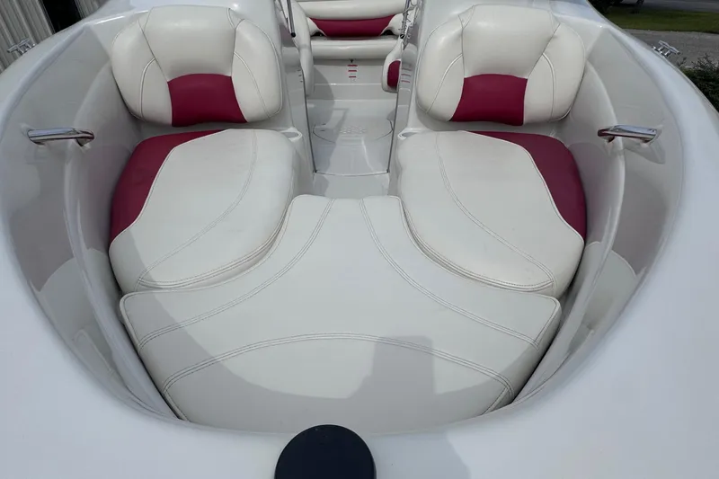 Slide: The Image of 2014 Tahoe Q5i boat interior with white and red cushioned seating. - 7