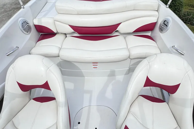 Slide: The Image of 2014 Tahoe Q5i boat interior with white and red cushioned seating. - 9