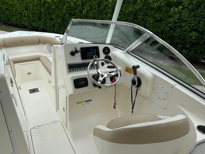 Slide: The Image of 2016 Key West 239 DFS boat interior with steering wheel and seating. - 5
