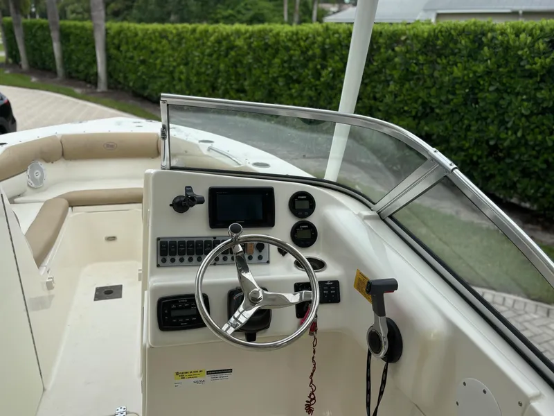 Slide: The Image of 2016 Key West 239 DFS boat dashboard with steering wheel and controls. - 6