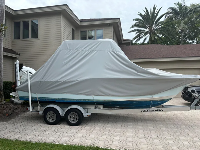 Slide: The Image of 2016 Key West 239 DFS boat covered on trailer in residential driveway. - 7