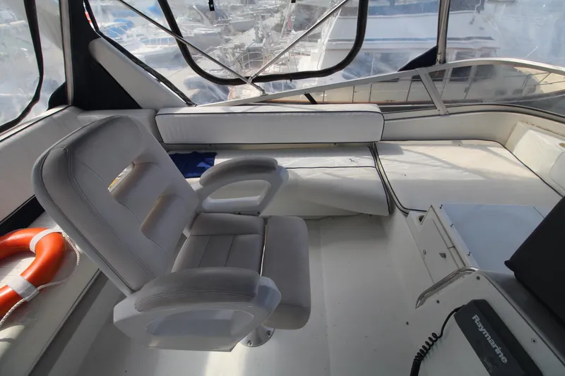 Slide: The Image of Captain's chair in 1995 Carver 370 Voyager yacht cockpit, featuring panoramic windows. - 11