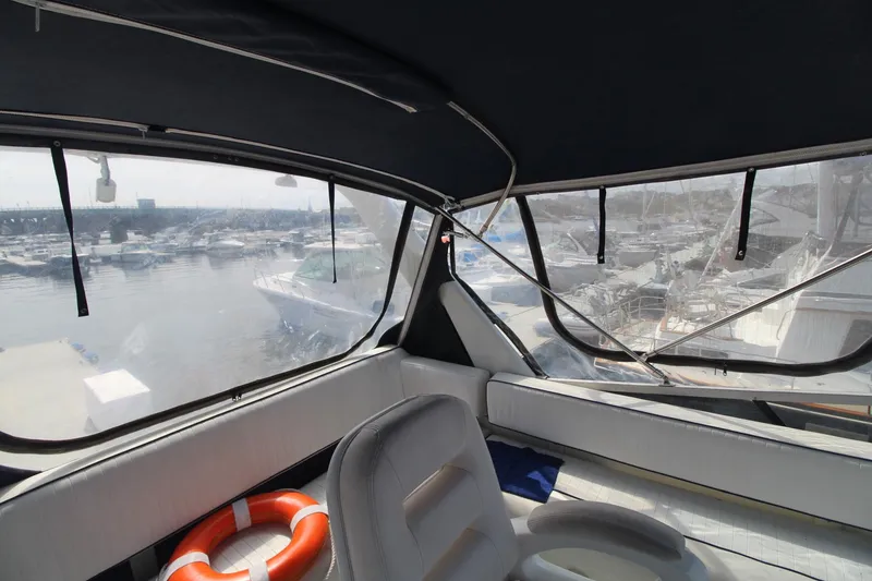 Slide: The Image of Interior view of 1995 Carver 370 Voyager yacht with marina backdrop. - 13