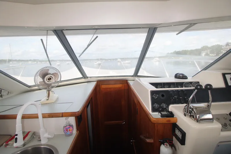 Slide: The Image of Interior view of 1995 Carver 370 Voyager yacht cockpit with steering controls. - 14