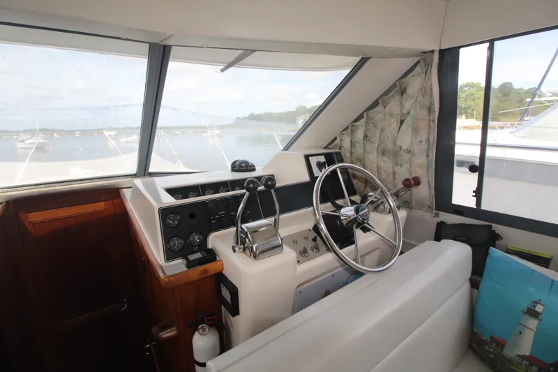 Slide: The Image of 1995 Carver 370 Voyager helm with steering wheel and control panel. - 15