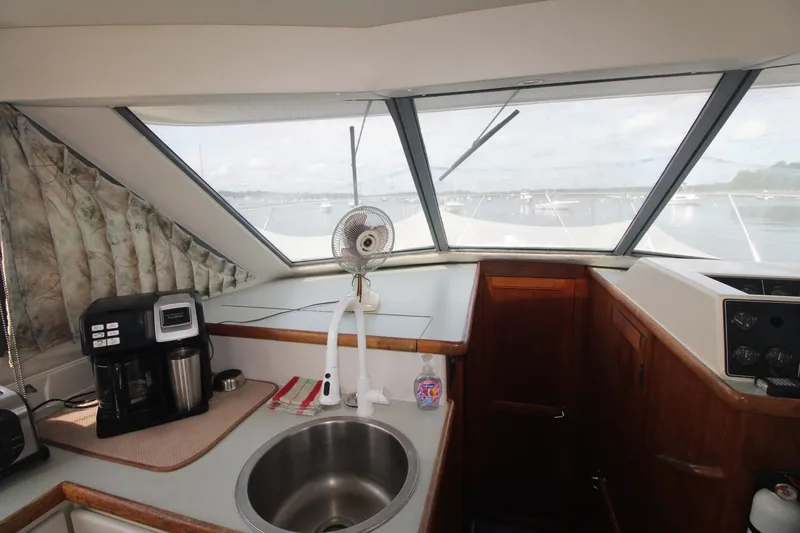 Slide: The Image of Interior of 1995 Carver 370 Voyager yacht with kitchenette and panoramic windows. - 16