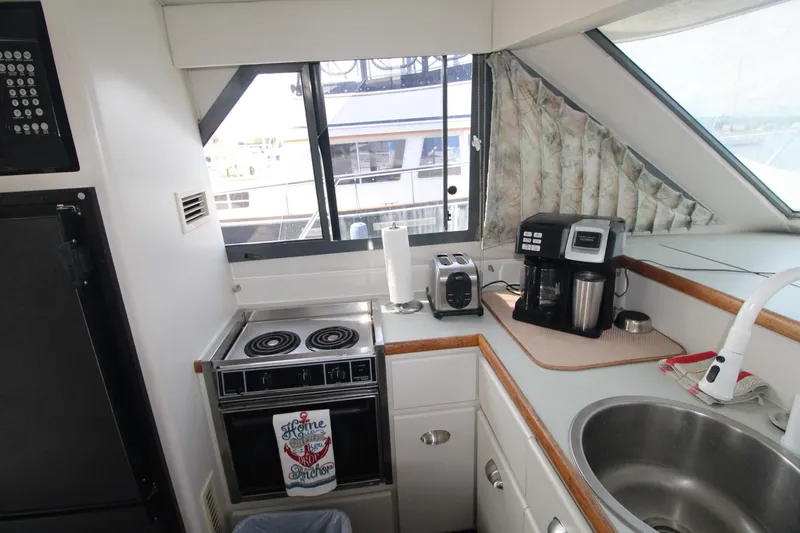 Slide: The Image of Compact kitchen area in a 1995 Carver 370 Voyager yacht with appliances and sink. - 17