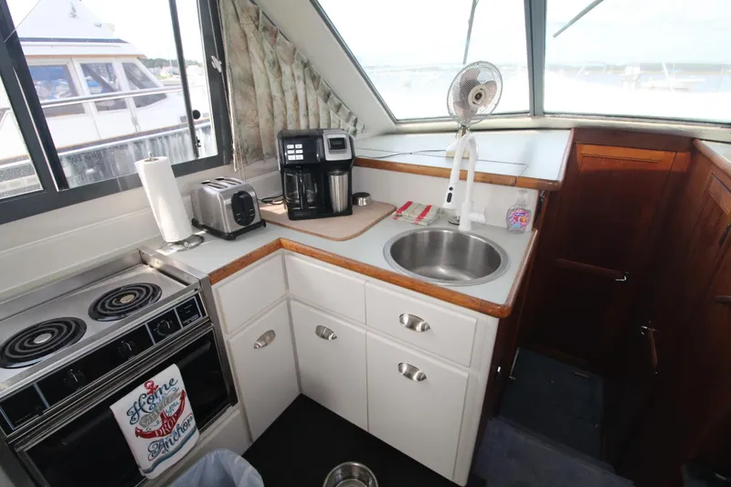 Slide: The Image of 1995 Carver 370 Voyager kitchen with stove, sink, and appliances. - 18