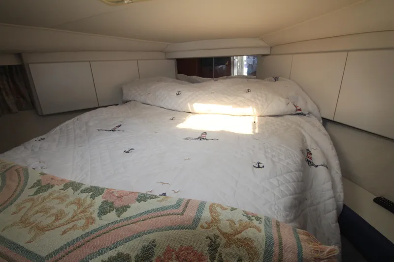Slide: The Image of Cozy bedroom in 1995 Carver 370 Voyager yacht with nautical-themed bedding. - 22
