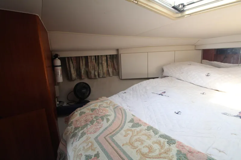 Slide: The Image of Cozy bedroom interior of 1995 Carver 370 Voyager yacht with patterned bedding and natural light. - 23