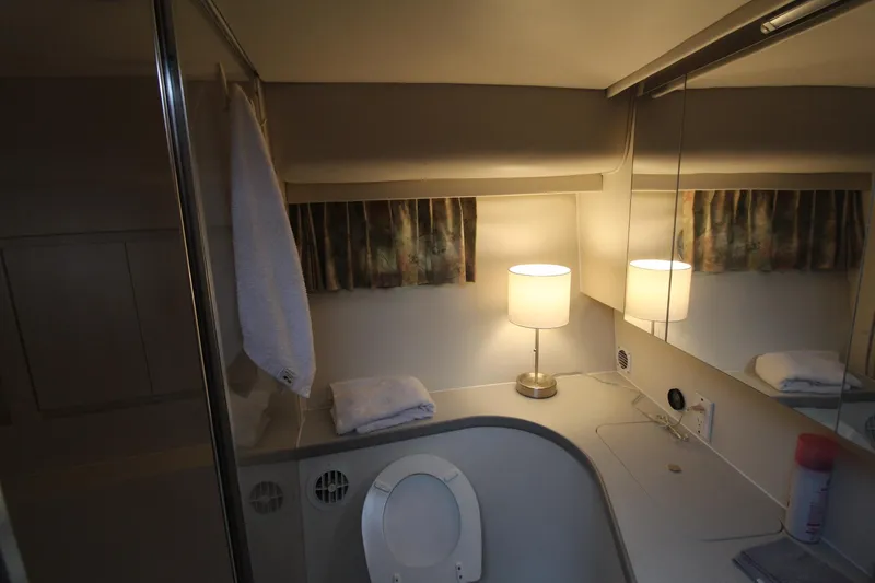 Slide: The Image of Bathroom interior of 1995 Carver 370 Voyager with lamp, mirror, and toilet. - 26
