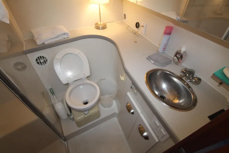 Slide: The Image of Bathroom interior of 1995 Carver 370 Voyager yacht with sink and toilet. - 28