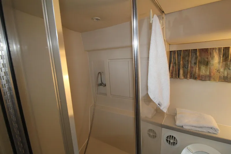 Slide: The Image of Bathroom interior of 1995 Carver 370 Voyager yacht with shower and towel. - 30